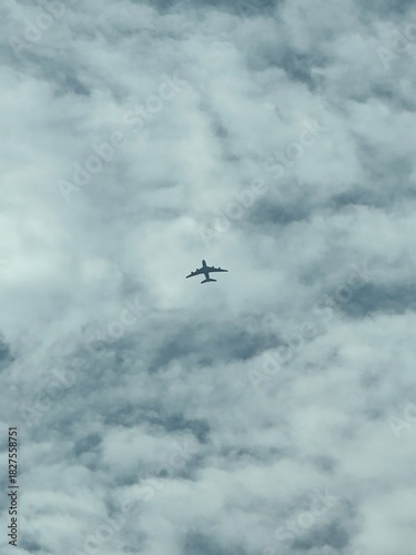 Airplane Silhouette Flying Above the Clouds