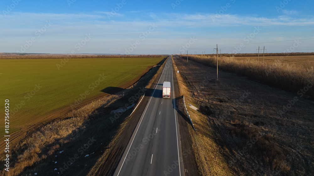 Fototapeta premium trucks carrying cars are driving on the highway in early spring