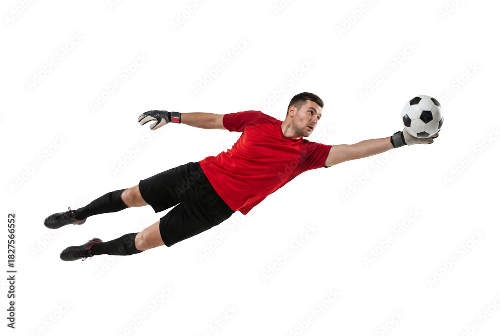 Fototapeta premium Soccer goalkeeper diving to catch ball in mid air on isolated background, athletic male making save with gloves and focused expression for sport training, competition and team defense concepts