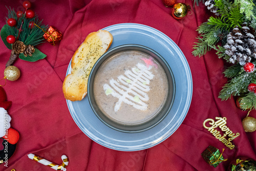 Festive soup with a bread on a christmas table. The delicious soup decorated as a Christmas tree