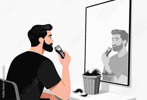 A man shaves his beard with an electric trimmer while looking in a mirror, a trash can nearby collects trimmings