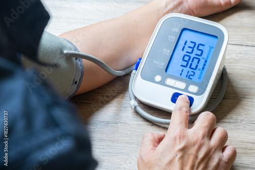 Tableau sur toile Man check blood pressure monitor and heart rate monitor with digital pressure gauge