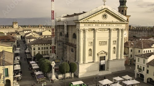 Drone ascending over cittadella cathedral and medieval walls