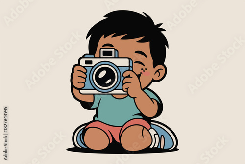 Cute cartoon boy with dark hair, freckles, rosy cheeks, holding up a camera, in a sitting pose