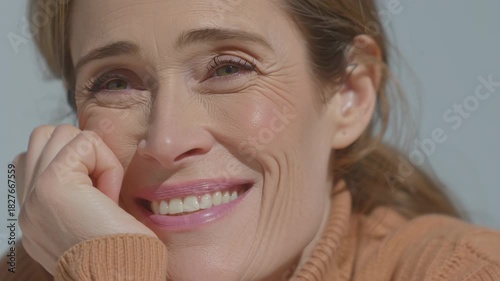 Close-up of a happy woman with a radiant smile, showcasing genuine joy and contentment.
