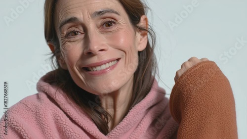 Close-up of a smiling mature woman with a warm expression.