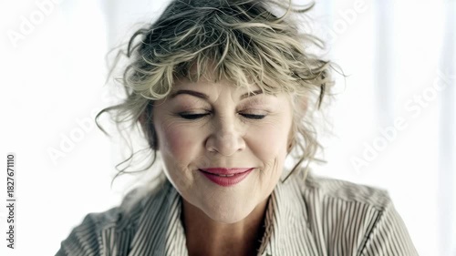 Joyful Senior Woman with Curly Hair and Bright Smile.