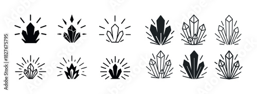 Set of black crystal icons with radiating light design elements