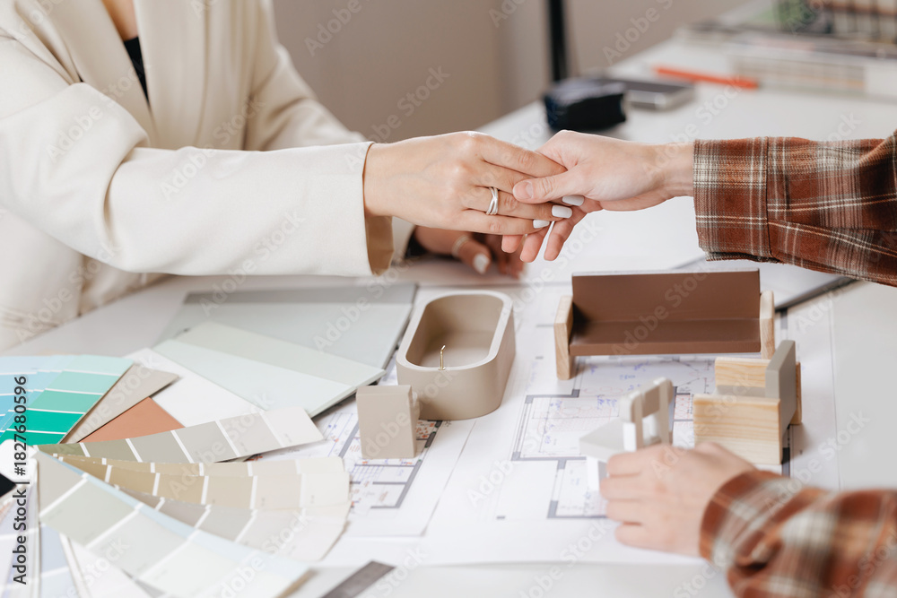 Obraz premium Agreement between client and designer. Collaborative discussion between women on architectural design concepts