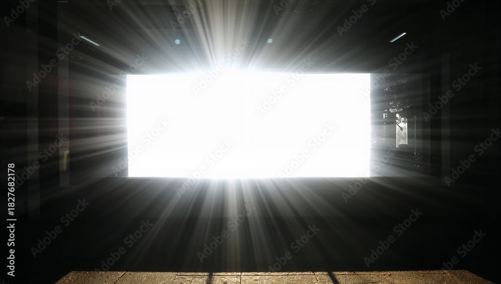 Obraz premium Streaming sunlight pouring through bright rectangular opening in parking garage, casting long beams