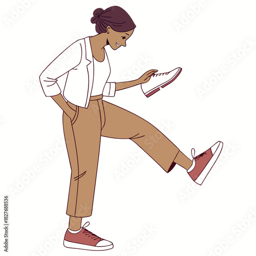 Woman examining a shoe while standing with one leg raised girl footwear