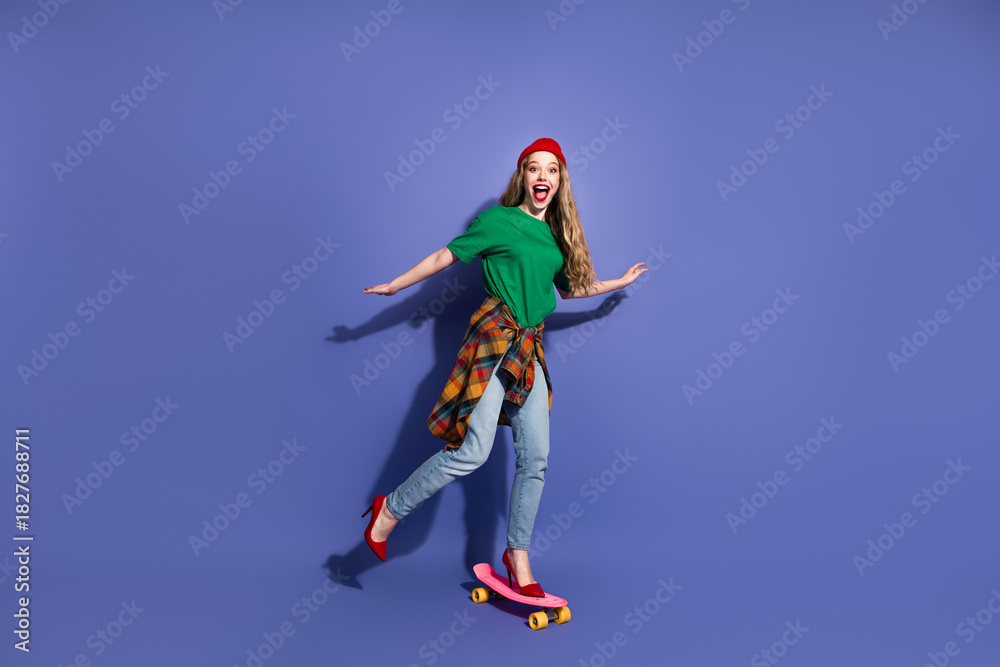 Naklejka premium Young woman skateboarding in casual street wear shirt plaid tied jacket jeans purple background for fun fashion lifestyle and advertising imagery