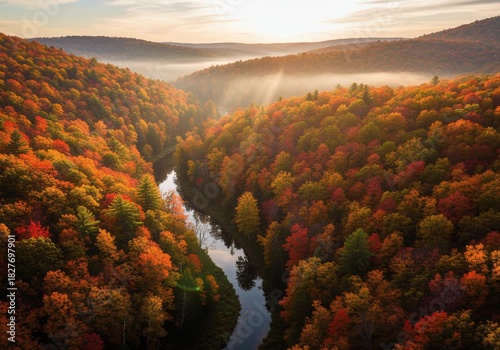 Morning sunlight over winding river in colorful autumn forest