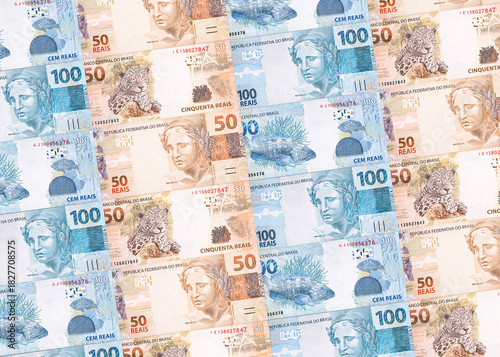 Background texture of Brazilian money banknotes, 100 and 50 reais notes, background for video or scenery. Concept of award or payment, fortune.