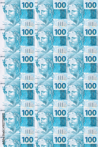 Background texture of Brazilian money bills, 100 reais notes, background for video or scenery. Concept of award or payment, fortune.