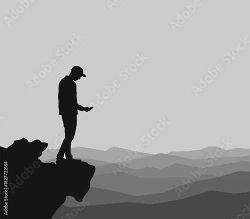 Man using a mobile phone in a mountain landscapeMan using a mobile phone in a mountain landscape
