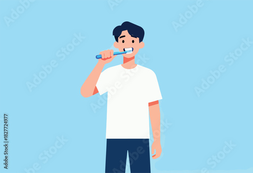 A person in a white shirt and blue pants brushes their teeth with a blue toothbrush against a light blue backdrop