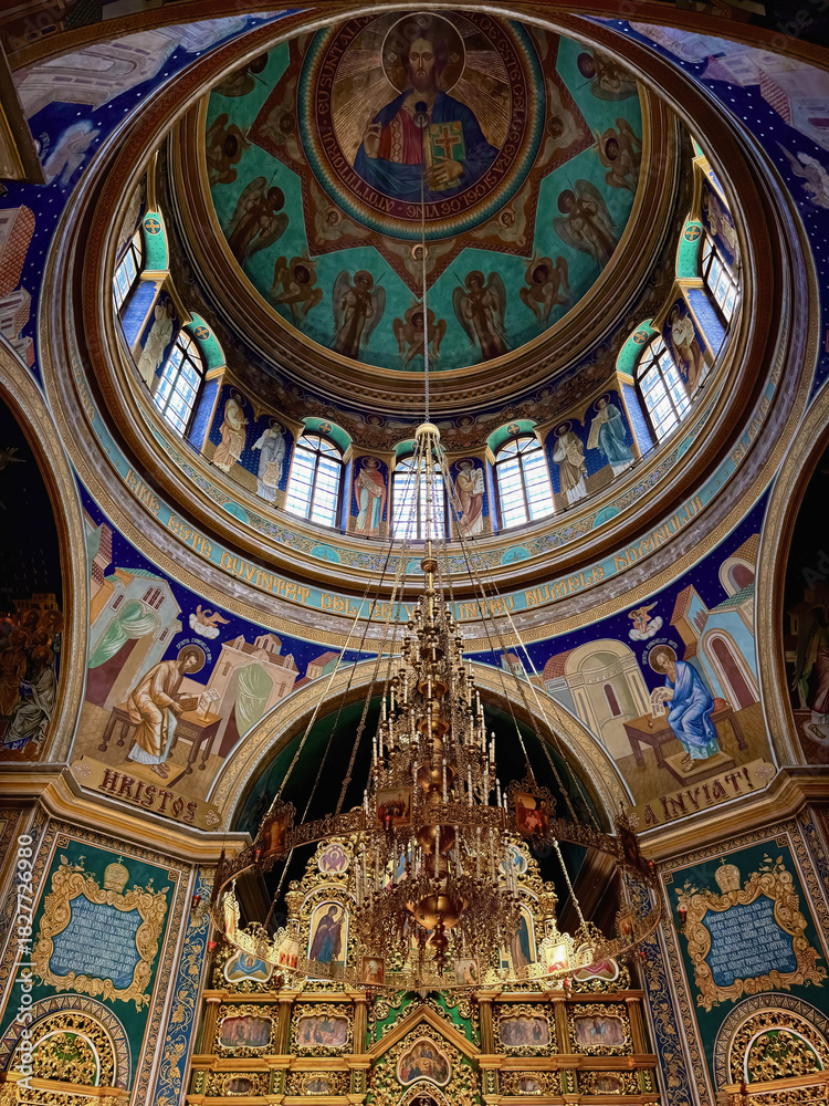 Obraz premium Interior of the Nativity of Christ Cathedral in Chisinau, Moldova: gilded chandelier, decorated iconostasis and dome with Christ .