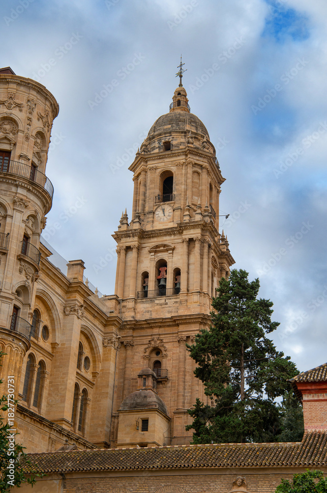 Naklejka premium View of Cathedral of Málaga tower (Santa Iglesia Catedral Basílica de la Encarnación), Malaga , Andalusia, Spain. Roman Catholic church. Religious concept.