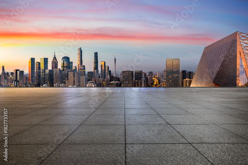 Empty square floor and city skyline with modern commercial buildings at sunrise in Guangzhou