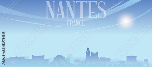 Blue panoramic poster of the city skyline with misty background buildings and clouds of NANTES, FRANCE