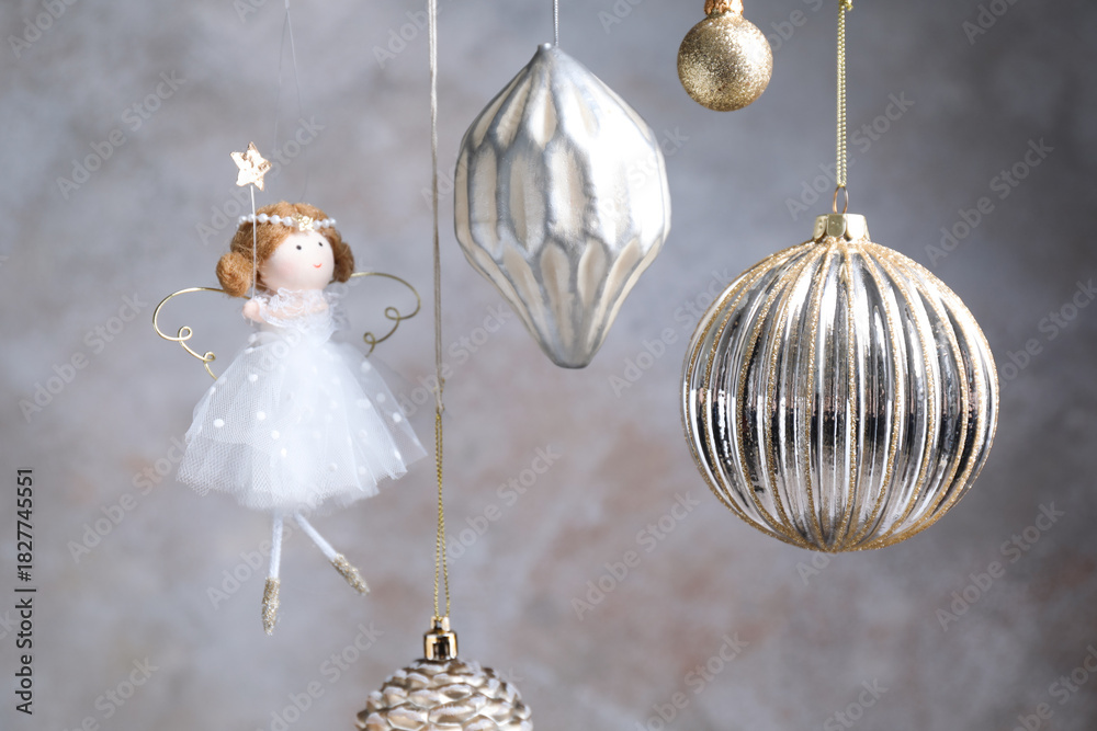 Fototapeta premium Beautiful Christmas decor hanging near light grey wall, closeup