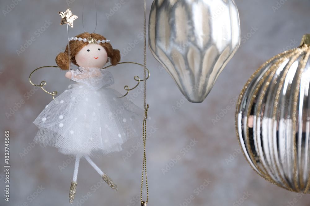 Fototapeta premium Beautiful Christmas decor hanging near light grey wall, closeup