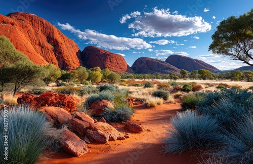 the iconic rock formations at avonite in australia, featuring three large red rocks standing side by side against a clear blue sky.