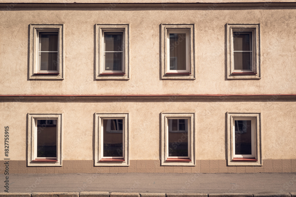 Fototapeta premium Building facade with aligned rows of minimalist windows