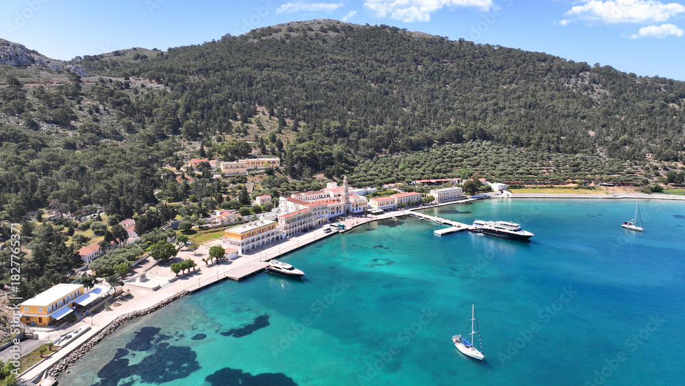 Obraz premium Aerial drone photo of iconic bay and holy Monastery of Archangel Michael Panormitis, Symi island, Dodecanese, Greece