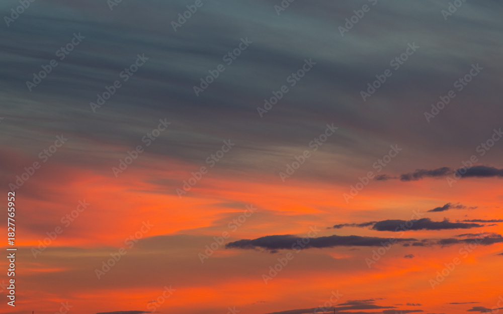 Fototapeta premium Beautiful sunset sky with orange colored clouds.
