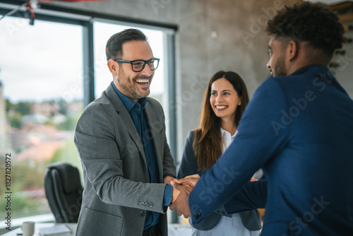 Photography Business people shaking hands celebrating partnership deal in office