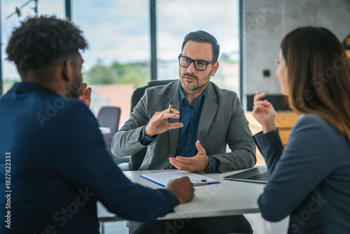 Canvas Print Financial adviser discussing contract with diverse couple in office meeting