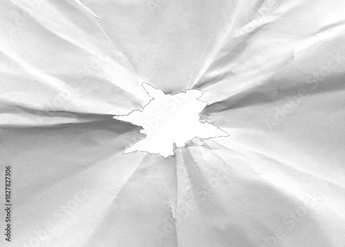 Hole in crumpled paper with torn edges isolated on transparent background.