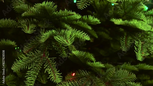 Look at the artificial Christmas tree. Panning from bottom to top. The decoration mimics a real Christmas tree.