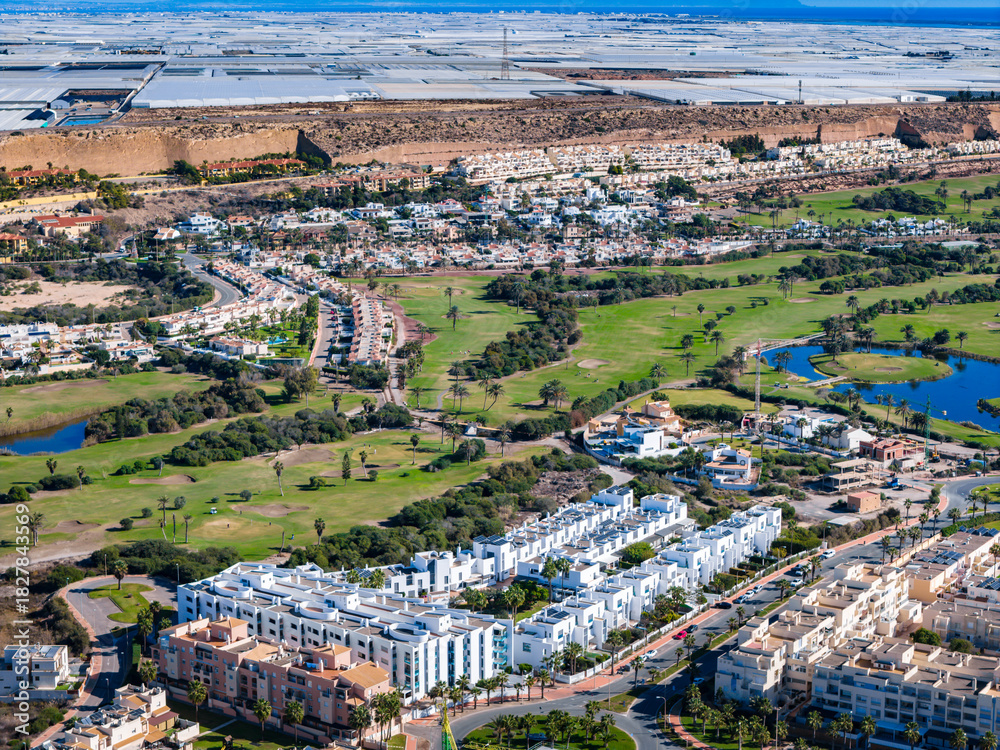 Naklejka premium Aerial View of the Golf Course and New Condo Construction Site in Almerimar, on the Mediterranean Coast of Andalusia