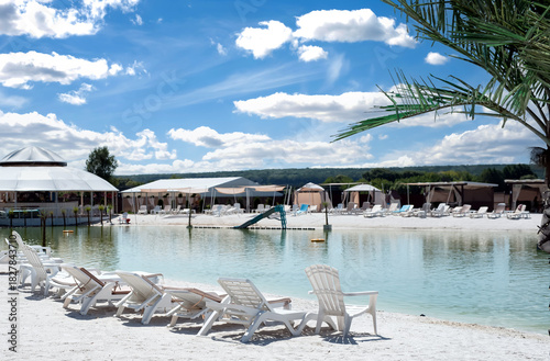 Wallpaper Mural Recreation complex with sun loungers and a covered tent with a pond Torontodigital.ca