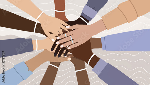 Diverse group of people stacking hands in a symbol of unity and teamwork against a neutral background with a flat lay composition.