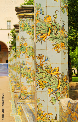 View of the colorful tiled columns of the cloister of Santa Chiara in Naples, Campania, Italy.