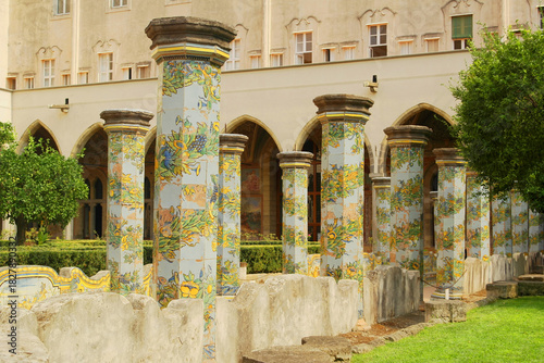 View of the colorful tiled columns of the cloister of Santa Chiara in Naples, Campania, Italy.