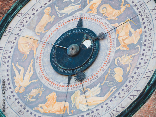 Astronomical clock face on Torrazzo bell tower in Cremona, Italy displaying zodiac signs and months