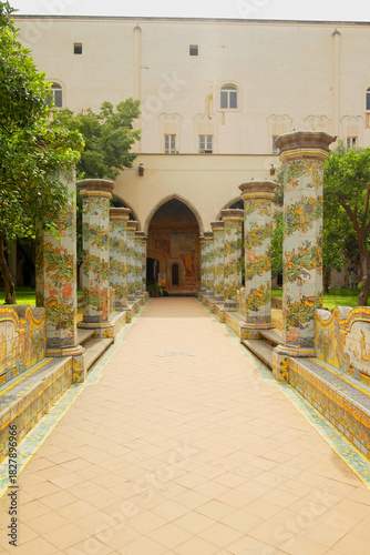 View of the colorful tiled columns of the cloister of Santa Chiara in Naples, Campania, Italy.