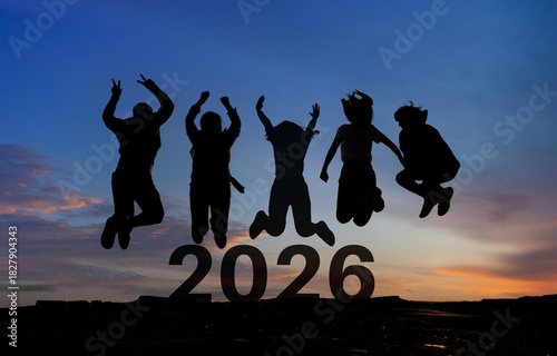 Happy group of people celebrate jump for new year 2026. concept for win victory. silhouette of friends jumps at sunset time on mountains.