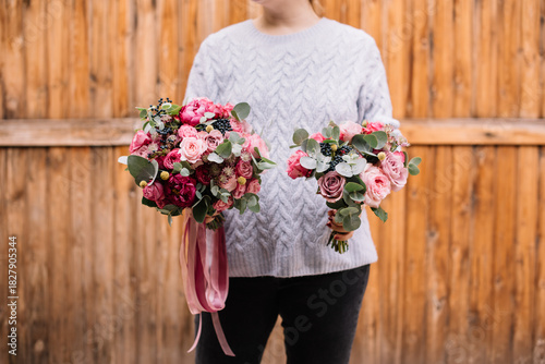 Wallpaper Mural Very nice young woman holding two beautiful bouquet of fresh roses, carnations, eucalyptus and other flowers in tender and vivid pink colors Torontodigital.ca