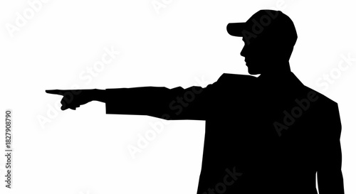 Silhouette of a man pointing with his finger towards something.