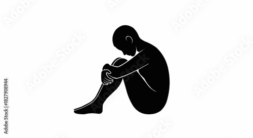 Silhouette of a sad and lonely person sitting in a fetal position.