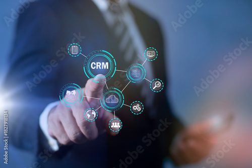 Customer relationship management, CRM Concept, Businessman touching CRM icon on virtual interface, relationship management, data analysis, personalization, automation, customer satisfaction.