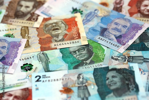 Colombian pesos money bills banknotes lies in big pile on table close up. Concept of finances and business in Colombia