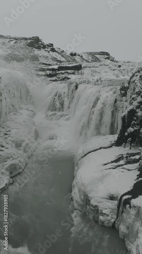 Powerful waterfall in Iceland plunging through dramatic cliffs into a misty gorge, capturing the raw beauty of untouched Nordic nature and epic volcanic landscapes.