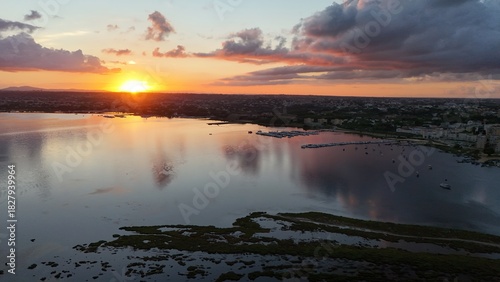 Fototapeta Naklejka Na Ścianę i Meble -  Insanely beautiful drone photography of a scenic sunrise, early in the morning, by the salt marshes in Marsala, Sicily, during a lovely morning.	